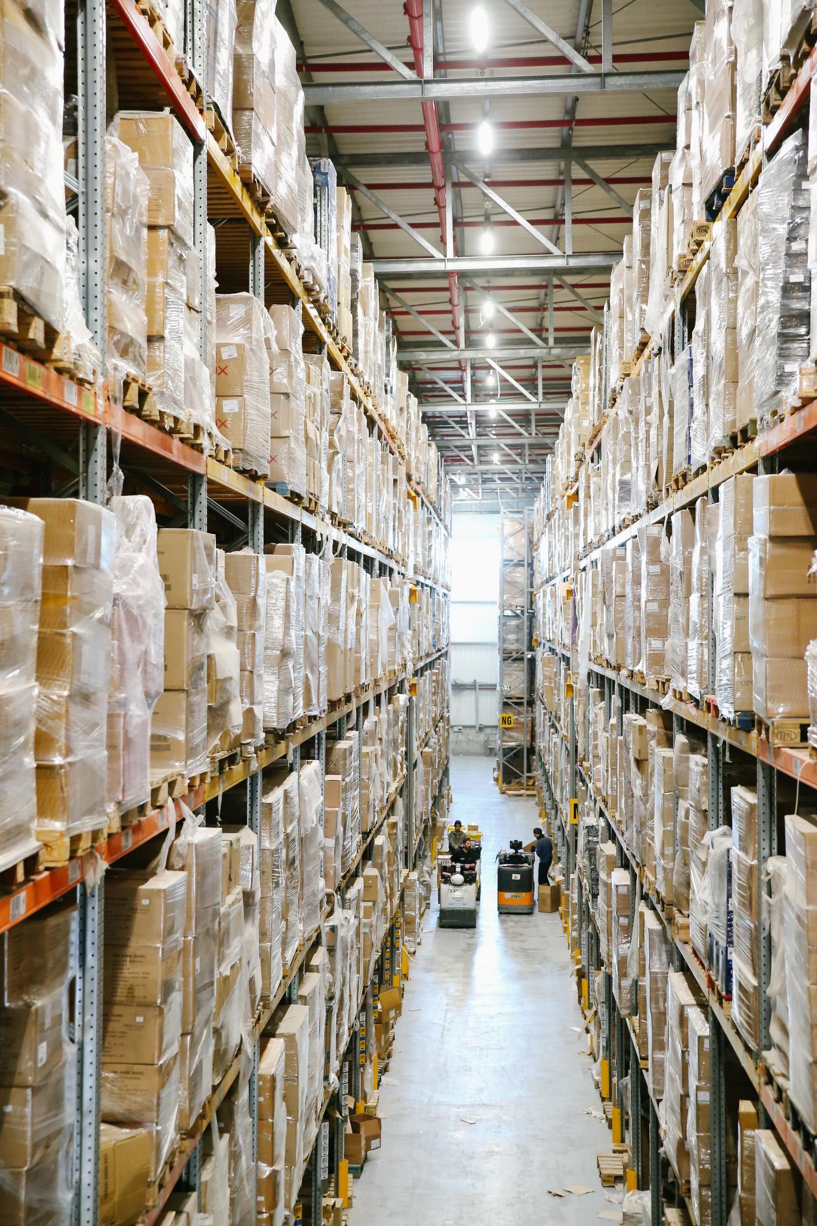 Palletized cartons arranged on tall racks along a warehouse aisle